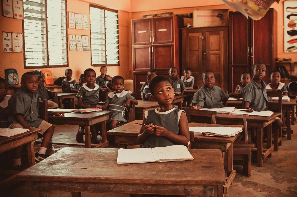Children seated in a classroom during a lesson.