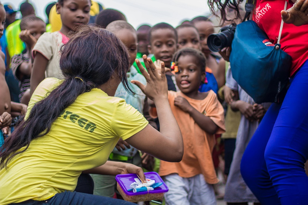 Volunteer engaging children during a community outreach activity.